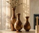 Set of three handcrafted Sidr wood vases — front view showing rich swirling grain